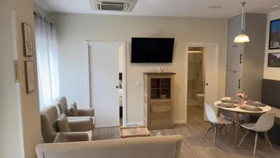 a living room with a couch and a table with chairs at Pension Lugo FINGOI in Lugo