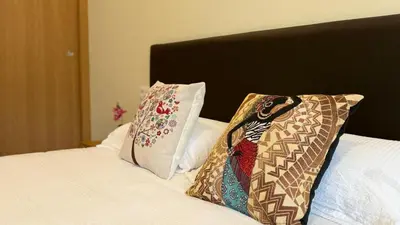 two pillows sitting on top of a bed at Pension Lugo FINGOI in Lugo