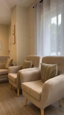 a waiting room with couches and chairs and a window at Pension Lugo FINGOI in Lugo