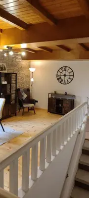 a room with a staircase with a clock on the wall at Costa A Mariña in Barreiros