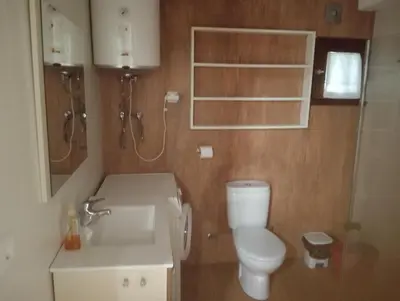 a bathroom with a white toilet and a sink at Xulia in Viavélez