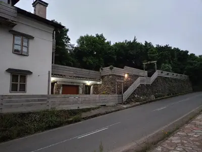 a house with a fence and stairs on the side of a road at Xulia in Viavélez