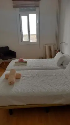 a bedroom with a large bed with two towels on it at Mirador San Rosendo, TOP Location in Ourense