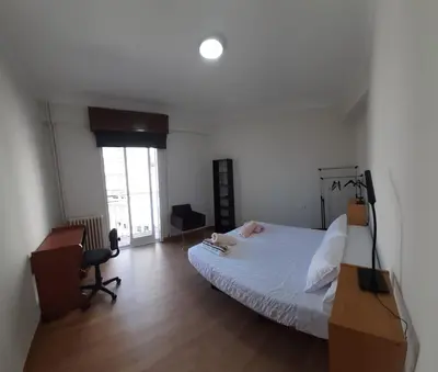 a bedroom with a bed and a desk and a window at Mirador San Rosendo, TOP Location in Ourense
