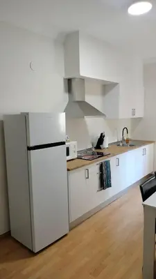 a kitchen with white cabinets and a white refrigerator at Mirador San Rosendo, TOP Location in Ourense