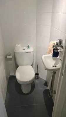 a white bathroom with a toilet and a sink at Mirador San Rosendo, TOP Location in Ourense