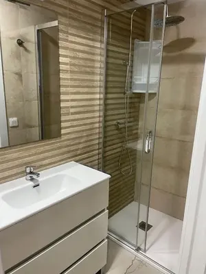 a bathroom with a sink and a shower at CASA CRISTINA Alojamiento céntrico en pleno casco histórico y centro de la ciudad in Monforte de Lemos