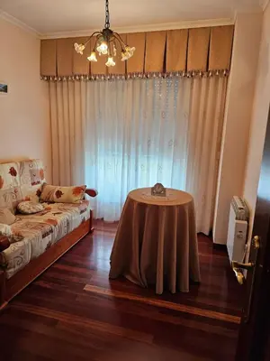 a bedroom with a table in the middle of a room at Luxurious downtown apartment in Ribadeo in Ribadeo
