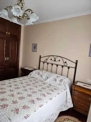 a bedroom with a bed with a quilt on it at Luxurious downtown apartment in Ribadeo in Ribadeo