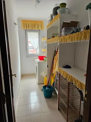 a room with a kitchen with shelves and a kitchen at Luxurious downtown apartment in Ribadeo in Ribadeo