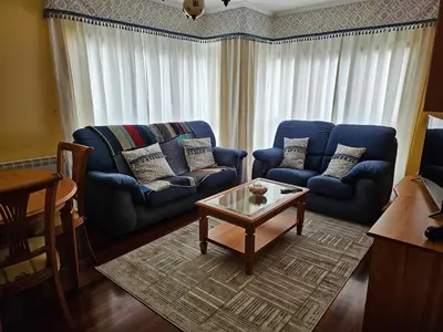 a living room with two blue couches and a coffee table at Luxurious downtown apartment in Ribadeo in Ribadeo