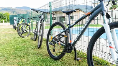 a group of bikes parked next to a fence at Xeocámping Montañas do Courel