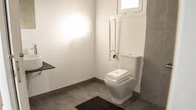 a bathroom with a toilet and a sink at Xeocámping Montañas do Courel