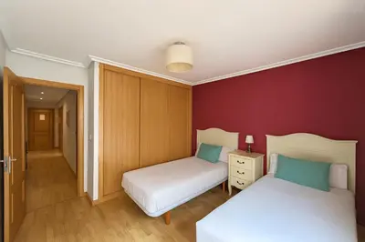 two beds in a room with red walls at Ribeira Sacra Suites in Nogueira de Ramuin