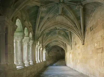 an aisle in an old building with arched ceilings at Parador de Santo Estevo in Santo Estevo de Rivas de Sil