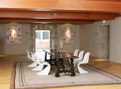 a dining room with a table and white chairs at Parador de Santo Estevo in Santo Estevo de Rivas de Sil