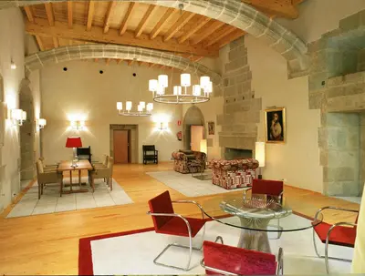a large living room with a table and chairs at Parador de Santo Estevo in Santo Estevo de Rivas de Sil