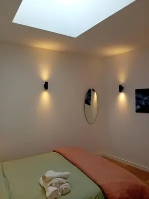 a bedroom with a bed with a mirror and lights at Hermosa Casa en Ribeira Sacra in Sistín