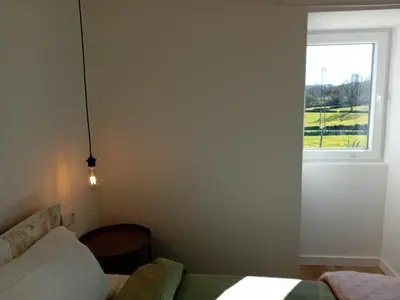 a bedroom with a bed and a window at Hermosa Casa en Ribeira Sacra in Sistín
