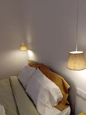 a bedroom with two lamps and a bed with pillows at Hermosa Casa en Ribeira Sacra in Sistín