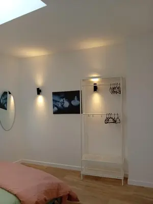 a bedroom with a bed and a white wall at Hermosa Casa en Ribeira Sacra in Sistín