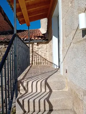 a shadow of a railing on a building with a balcony at Hermosa Casa en Ribeira Sacra in Sistín