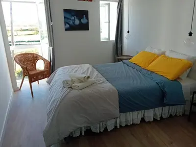 a bedroom with a bed with two towels on it at Duplex en Ribeira Sacra in Sistín