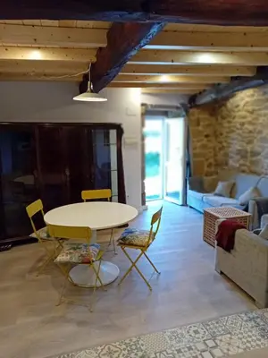 a living room with a table and chairs and a couch at Duplex en Ribeira Sacra in Sistín