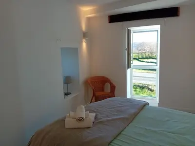 a bedroom with a bed with two towels on it at Duplex en Ribeira Sacra in Sistín