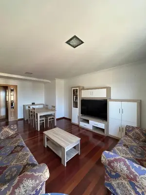 a living room with a couch and a coffee table at Piso Ría de Ribadeo in Ribadeo