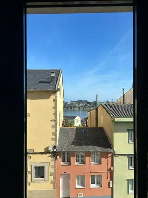 a view of some buildings from a window at Piso Ría de Ribadeo in Ribadeo