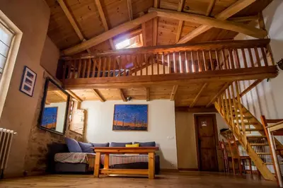 a loft with a staircase in a house at Casa Somoza in Castrillo De Los Polvazares