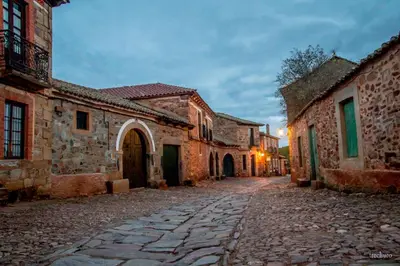 an empty street in an old town at dusk at Casa Somoza in Castrillo De Los Polvazares