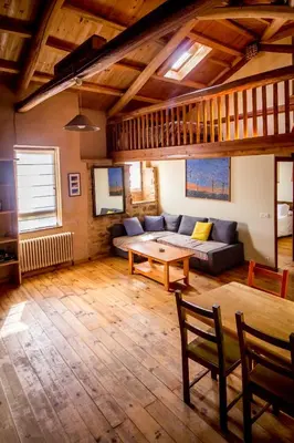 a living room with a couch and a table at Casa Somoza in Castrillo De Los Polvazares