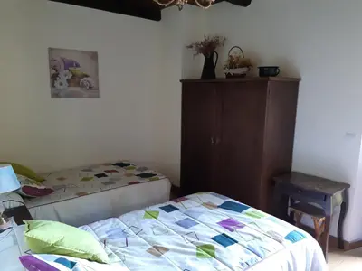 a bedroom with a bed and a dresser in it at Hospedaje - Ferrería Quintá in Quiroga