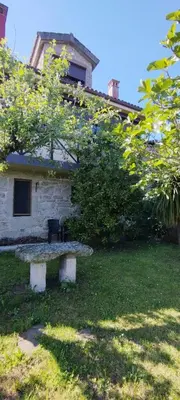 a stone bench sitting in front of a building at Casa mañoso in Cea