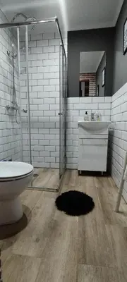 a bathroom with a shower and a toilet and a sink at O Recuncho do Lito