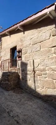 a stone building with a window and a balcony at O Recuncho do Lito