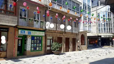 a street in a city with flags and buildings at Apartamento Loft II Select Real Caldas de Reis in Caldas de Reis