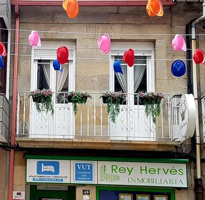 a group of balloons hanging from windows on a building at Apartamento Loft II Select Real Caldas de Reis in Caldas de Reis