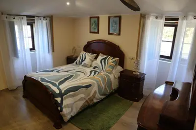 a bedroom with a bed and two windows at O'Regueiro