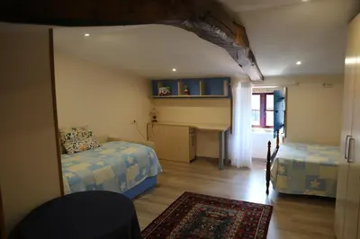 a bedroom with two beds and a mirror at O'Regueiro