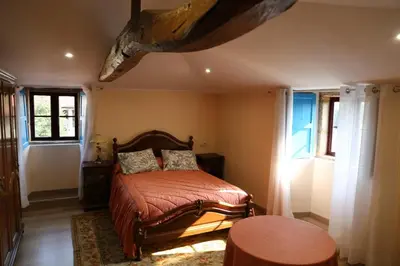 a bedroom with a bed in a room with windows at O'Regueiro