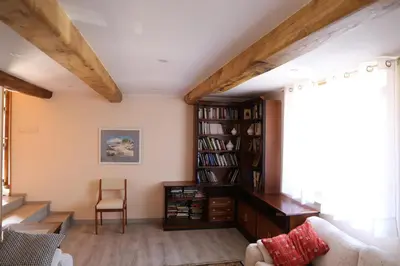a living room with a book shelf and a couch at O'Regueiro