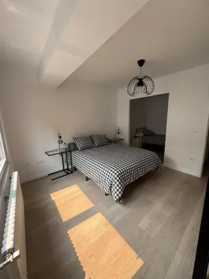 a bedroom with a bed with a checkered blanket at Civitas Augusta in Lugo