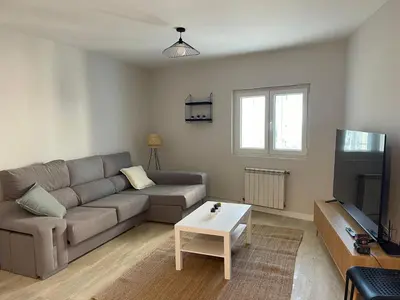a living room with a couch and a tv at Fogar en Soutelo in Forcarei