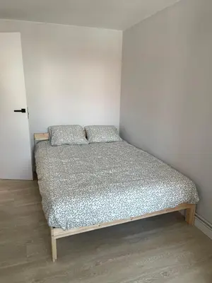 a bed with two pillows on it in a room at Fogar en Soutelo in Forcarei