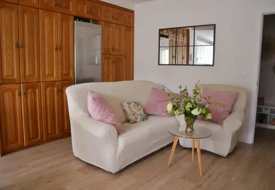 a living room with a couch and a table with flowers at Encanto de Oscos in San Martín de Oscos