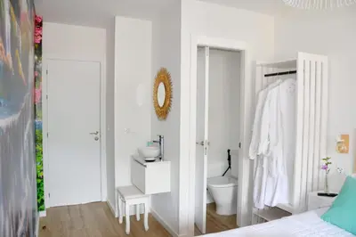 a white bathroom with a toilet and a sink at Encanto de Oscos in San Martín de Oscos