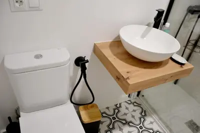 a bathroom with a sink on a counter next to a refrigerator at Encanto de Oscos in San Martín de Oscos